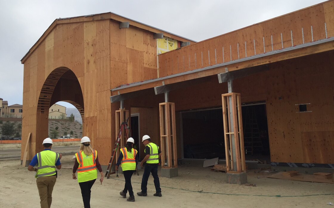 People Walking in front of contruction